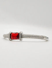 “Luxury silver women’s bracelet with bold red gemstone and Canadian-inspired modern jewellery design.”