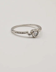 Close‑up view of the Silver Glow Heart Eternity Ring showcasing its polished silver band and brilliant heart centre stone; a Montreal minimalist jewellery favourite and clean girl jewellery trend for 2025