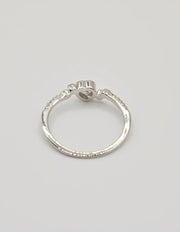 Angled shot of the Silver Glow Heart Eternity Ring on a seashell, showing the heart‑shaped centre stone and elegant pave setting; a clean girl jewellery 2025 favourite and thoughtful gift for her jewellery