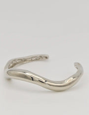 Close-up of bangle’s curved design and silver sheen